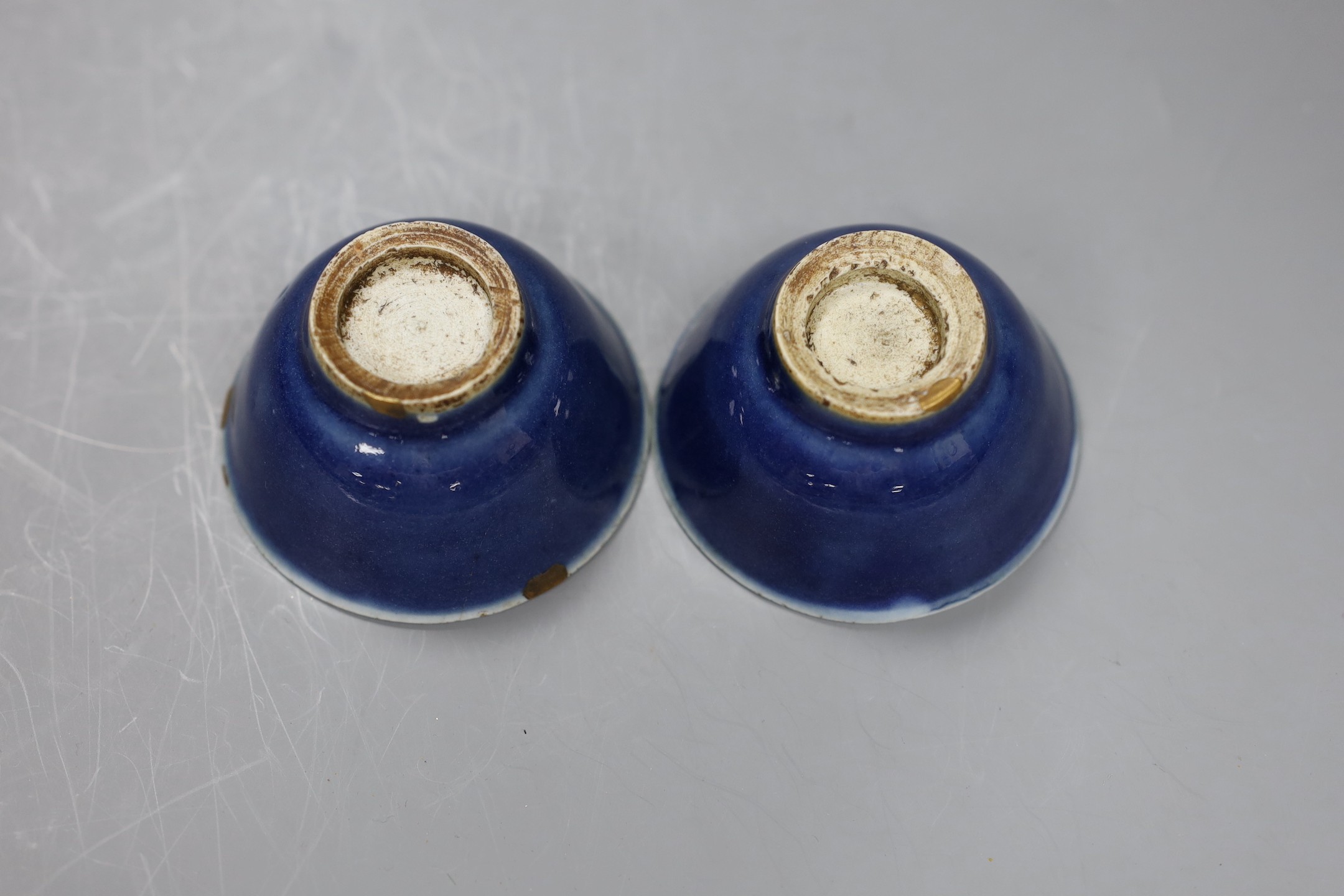 A pair of 18th century Chinese blue glazed cups, 3.5cm tall